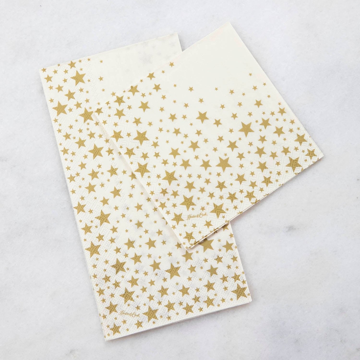 Two Shining Star Napkins, one Guest and one Cocktail, on a white table.