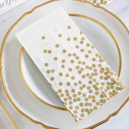 An elegant place setting featuring a Gold Confetti Guest Napkin on the plate, and a Gold Confetti Cocktail Napkin under the glass.