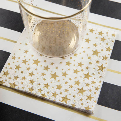 A Shining Star Cocktail Napkin under the water glass of an elegant place setting.