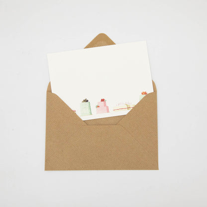A Cakes Flat Note with a kraft paper envelope, included.