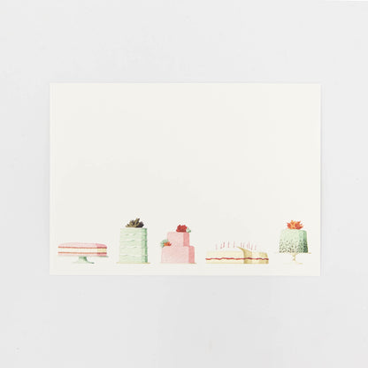 A Cakes Flat Notes card featuring an illustrated row of decadent cakes along the bottom of the white card.
