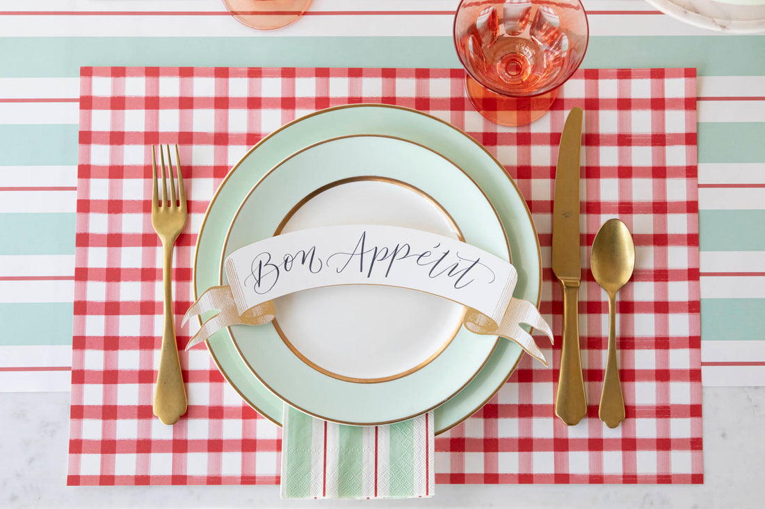 The Red Painted Check Placemat under an elegant place setting, from above.