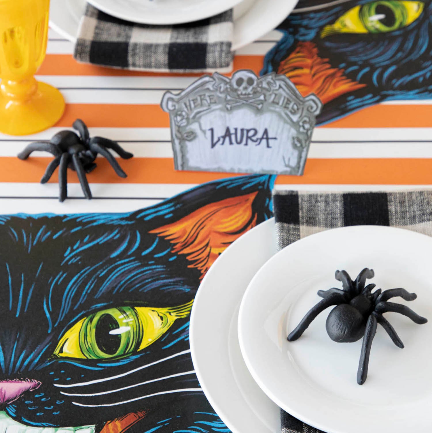 The Orange and Black Awning Stripe Runner under a spooky Halloween-themed tablescape.