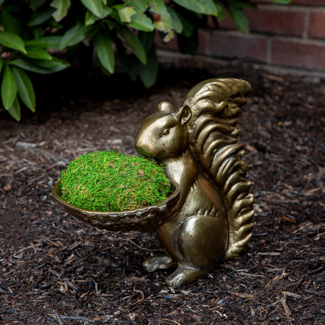 A bronze Accent Decor squirrel holding a bowl of moss.