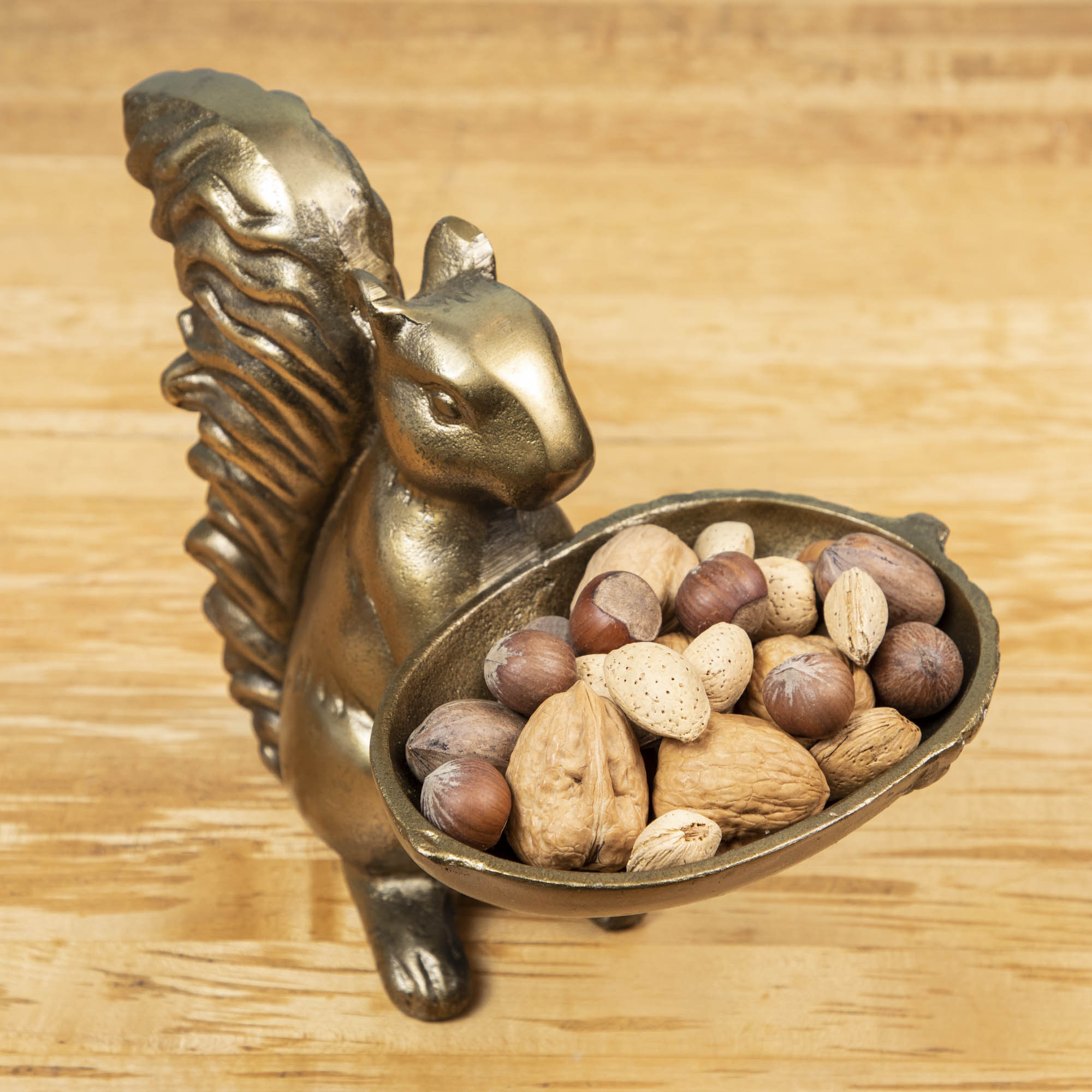 A bronze Accent Decor squirrel holding a bowl of moss.