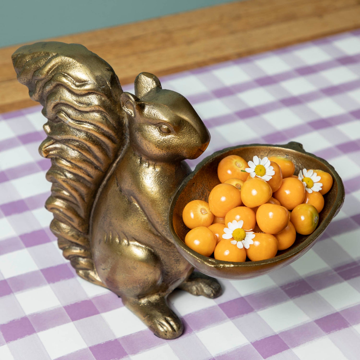 A bronze Accent Decor squirrel holding a bowl of moss.