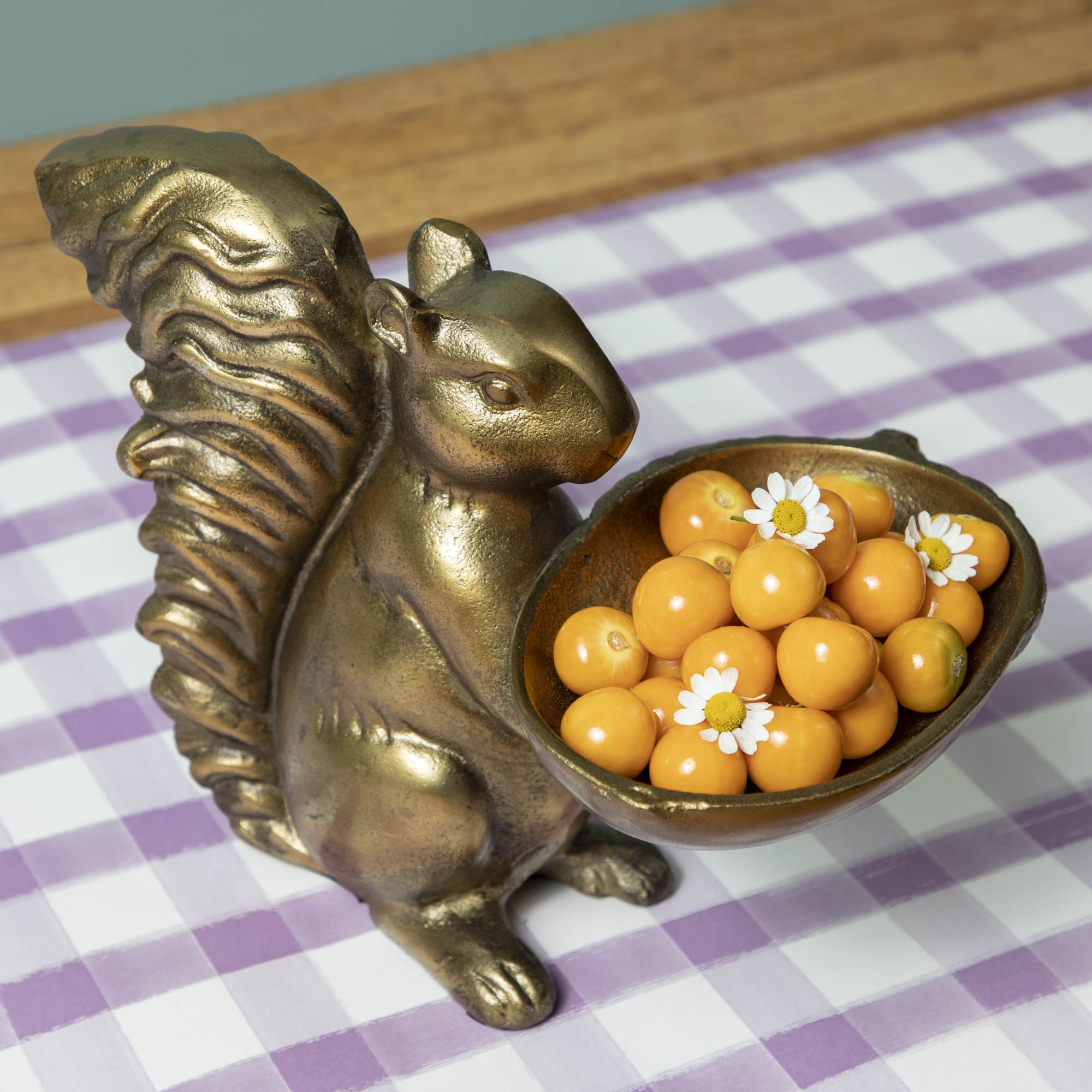 A bronze Accent Decor squirrel holding a bowl of moss.