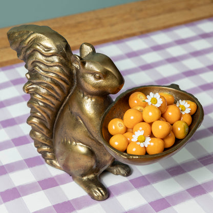 A bronze Accent Decor squirrel holding a bowl of moss.