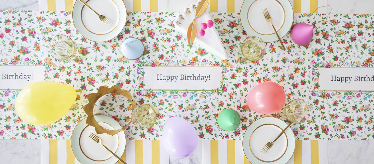 The Sweet Garden Personalized Runner under an elegant Birthday tablescape, with &quot;Happy Birthday!&quot; printed repeatedly in the frames, from above.