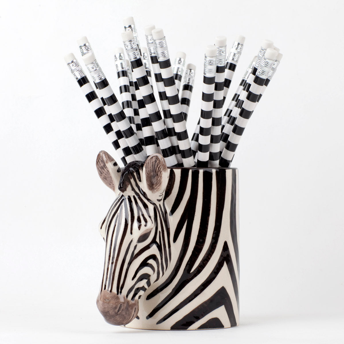 A set of Quail zebra ceramic vases on a wooden table.