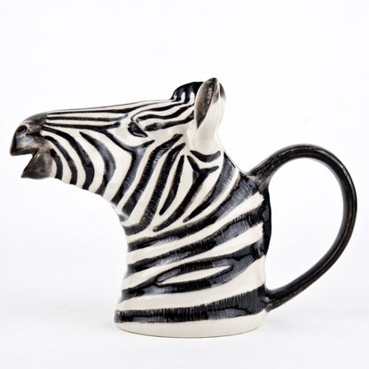 A set of Quail zebra ceramic vases on a wooden table.
