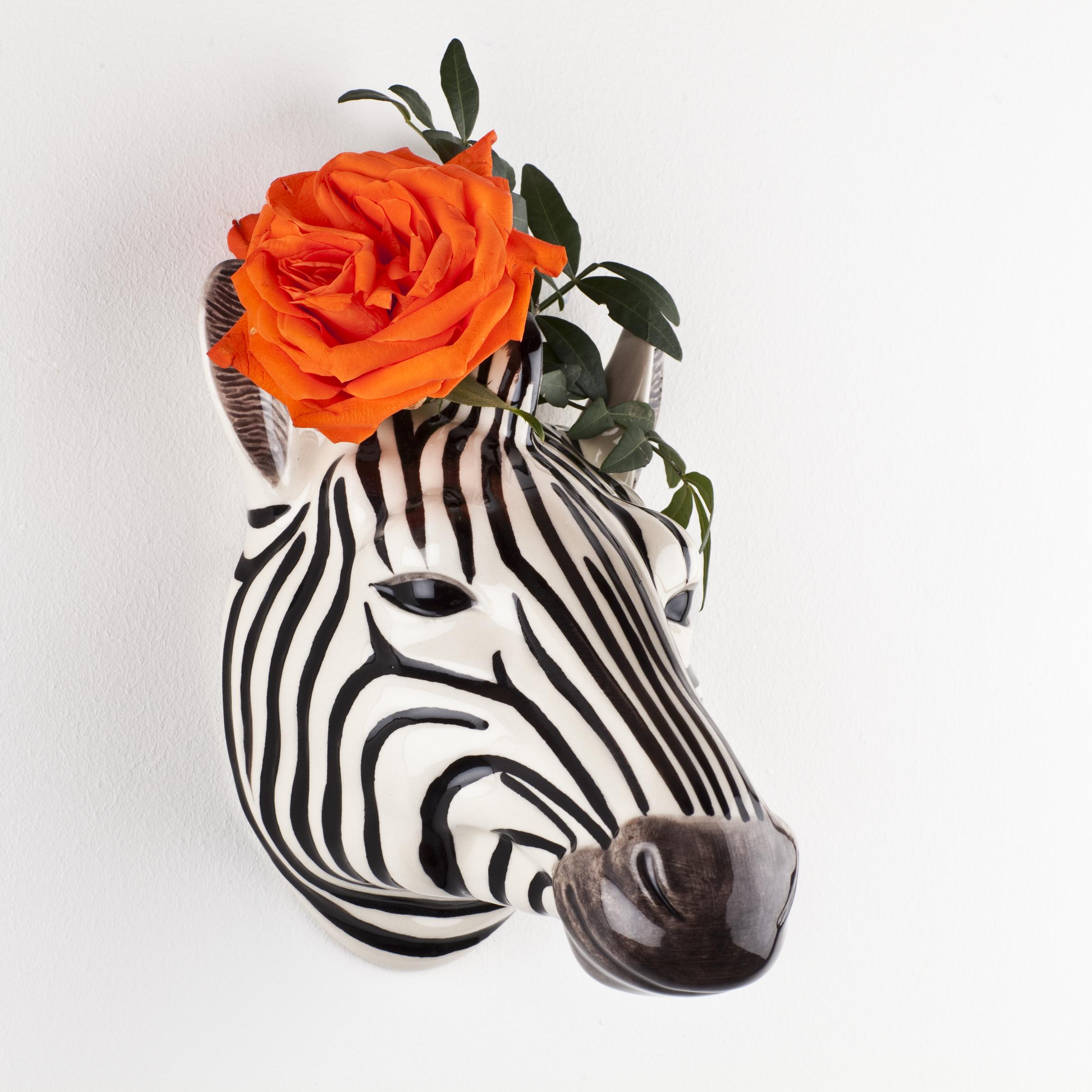 A set of Quail zebra ceramic vases on a wooden table.