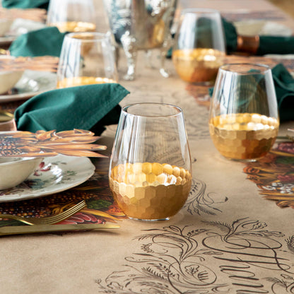 A table setting with Vitorrio Stemless Glassware plates, and napkins.