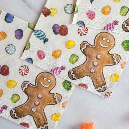 Close-up of three Gingerbread Cocktail Napkins, overlapping on a white table.