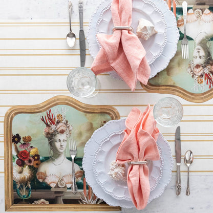 The Die-cut Goddess of the Sea Placemat under an elegant table setting for two, from above.