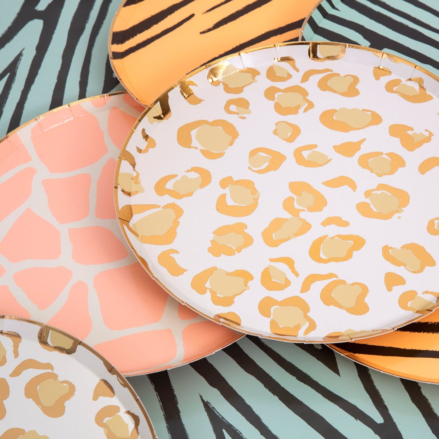 A set of four Safari Animal Print Plates by Meri Meri with a zebra animal print and gold foil detail on them.