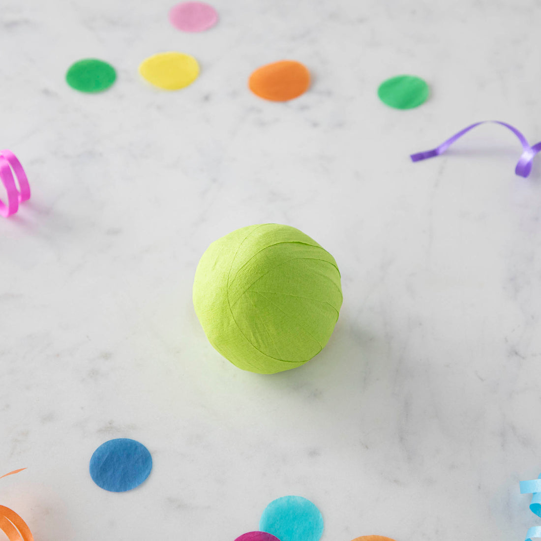 Vintage-inspired Mini Surprize Balls in a white bowl with confetti by Tops Malibu.