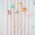 Five Glitterville Magic Wands on a striped background.