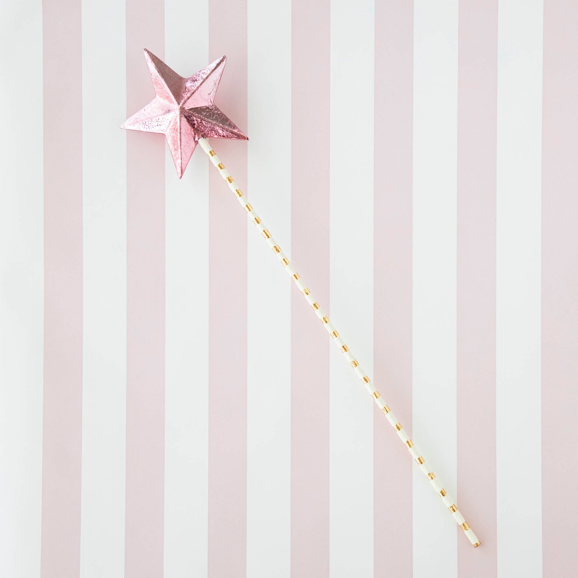 Five Glitterville Magic Wands on a striped background.