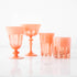 A set of four Rialto Salmon Glasses by SIR/MADAM on a white surface.