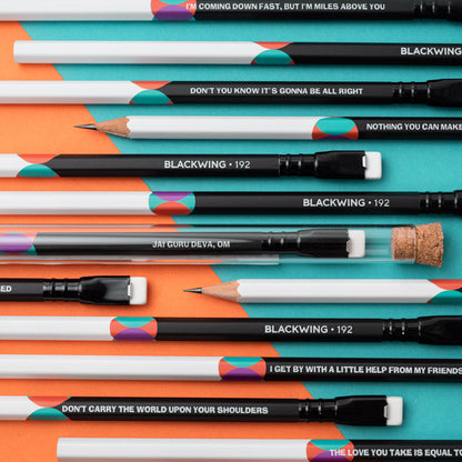A group of Blackwing Volume 192- Tribute to John Lennon and Paul McCartney (Set of 12) colored pencils with a quote on them about songwriting by John Lennon and Paul McCartney.