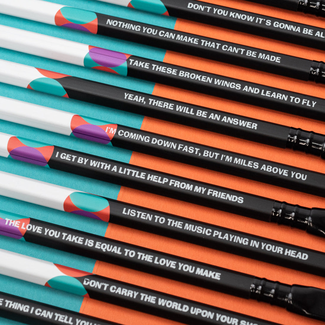 A group of Blackwing Volume 192- Tribute to John Lennon and Paul McCartney (Set of 12) colored pencils with a quote on them about songwriting by John Lennon and Paul McCartney.